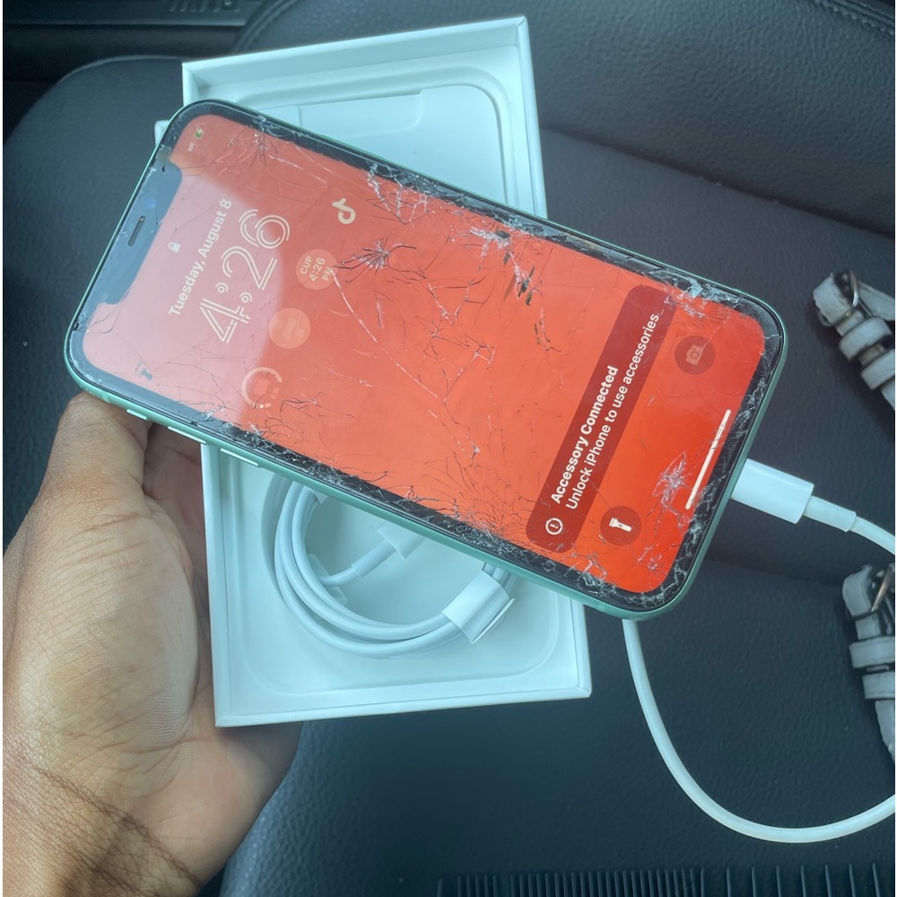 Severely shattered green Iphone 11
